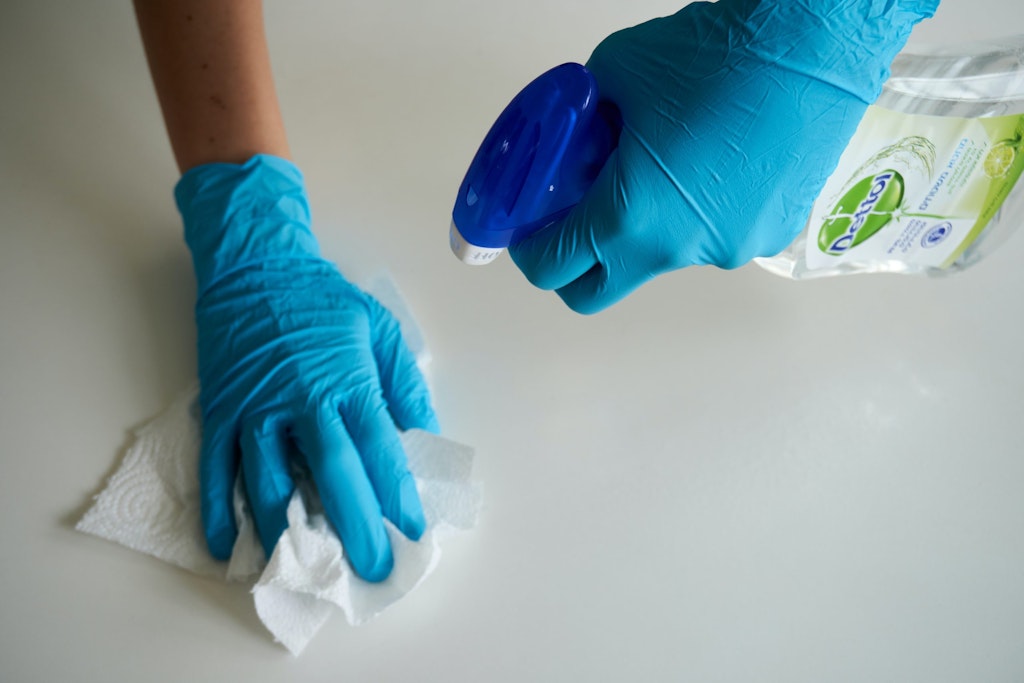 spraying and wiping a table