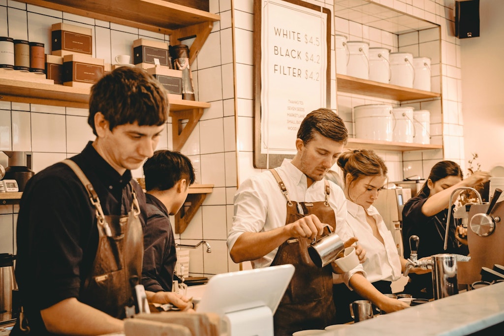 various restaurant staff behind the counter