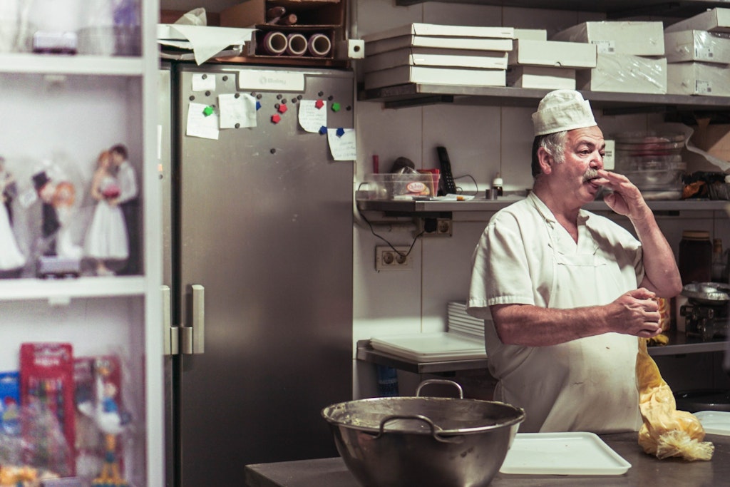 baker tasting his dough in kitchen