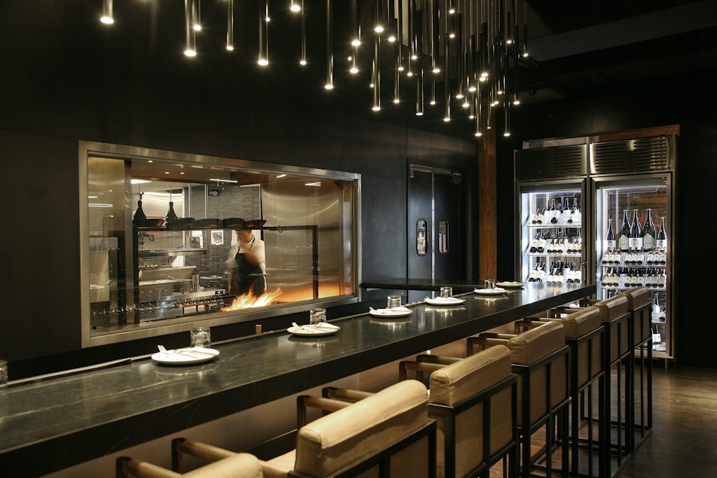 Restaurant bar seating area looking into kitchen