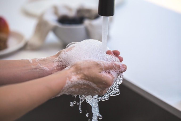 washing hands with soup